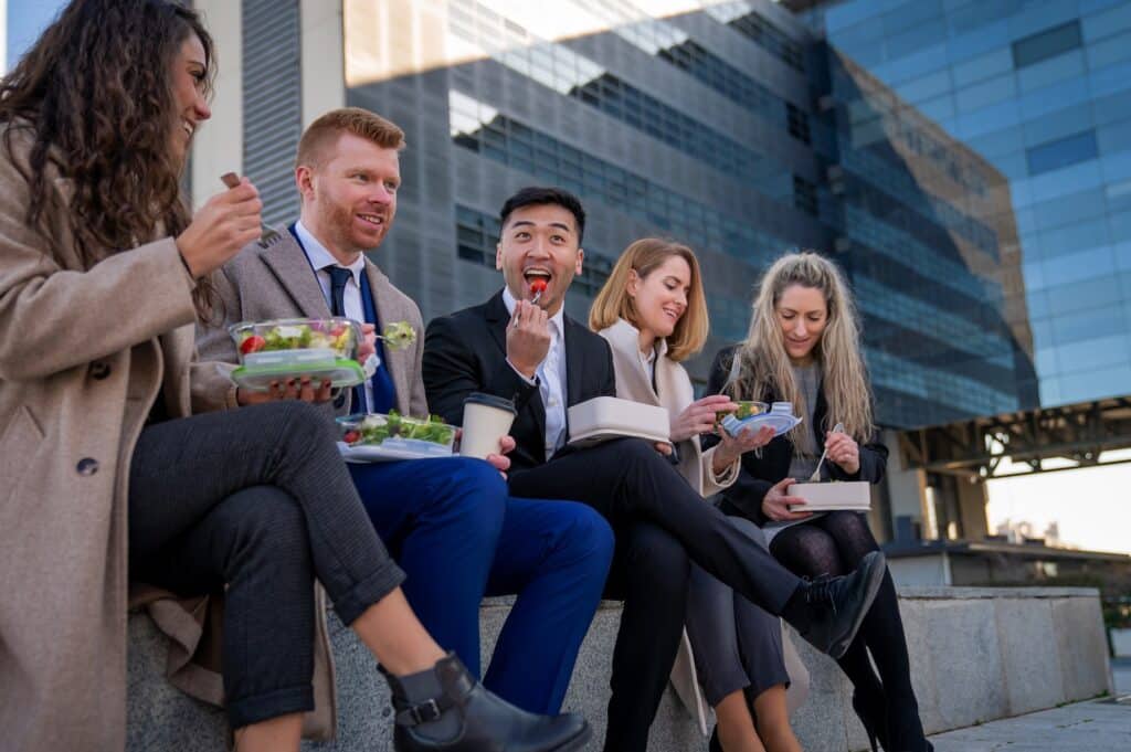 team away from their desks eating a healthy lunch
